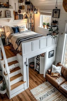 a loft bedroom with stairs leading up to the bed