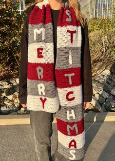 a woman wearing a red and white crocheted scarf with words written across it