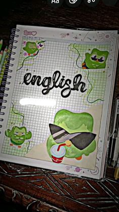 an open notebook with the word english on it and some cartoon characters in front of it