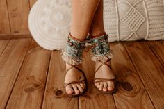 Elevate your footwear with these Ladies Beaded Ethnic Sandal Cuff Wraps featuring Tribal Feather Fringe and adornments. Perfect for festivals or boho chic outfits, these beaded ankle wraps add a unique touch to any sandals. The intricate beadwork and feather details create an eye-catching accessory, making every step stylish. Comfortable and easy to wear, they're the perfect addition to your fashion-forward wardrobe.  * This ad is for a pair of anklets; footwear is not included. * If you need a Bohemian Adjustable Anklets, Bohemian Ankle-wrap Sandals For Spring, Bohemian Ankle Wrap Sandals For Spring, Turquoise Open Toe Bohemian Sandals, Bohemian Ankle Wrap Sandals For Summer, Bohemian Summer Ankle Wrap Sandals, Bohemian Beaded Anklets For Spring, Bohemian Turquoise Anklets For Festivals, Bohemian Anklets For Vacation In Spring