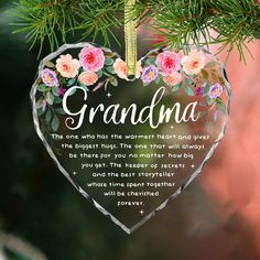 a heart shaped ornament hanging from a tree with the words grandma on it