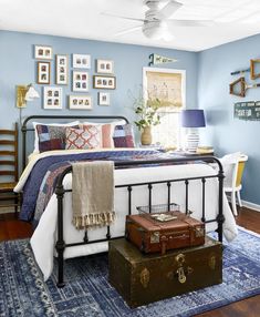 a bedroom with blue walls and pictures on the wall