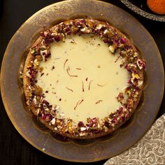 there is a pie on the table with other food items around it, including an orange slice