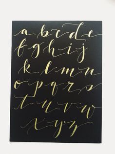 a black and gold calligraphy poster with the words, alphabets are written on it