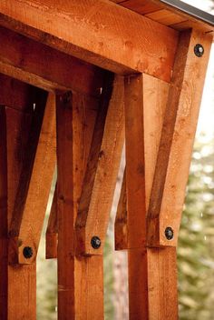 the top of a wooden bench with nails stuck in it's sidewalls