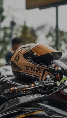 a helmet on top of a motorcycle parked in a parking lot next to other motorcycles