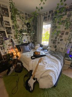 a bed room with a guitar laying on top of it