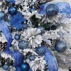 a blue and white christmas tree with ornaments