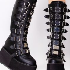 I Miss You, I Need You, And I Want You Now. Play With Their Minds When Wearing The Obssession Multi Strapped Platform Boots From Demonia. These Seductive Mid-Calf Platform Boots Feature A Black Vegan Leather Base, Eight Cone Studded Buckle Straps, Metal Zip Closure, And Black Contract Eva Foam Platforms. Leave Em' Totally Obsessed With You. 3 1/2" Platform Buckled Strap Knee Boot, Back Zip 3 1/2" (8.9cm) Platform Buckled Strap Knee High Boot With Chrome Plated Hardware On Straps, Full Back Zip Edgy Closed Toe Platform Boots With Buckle, Edgy Closed Toe Platform Boots With Buckle Closure, Gothic Leather Boots For Spring, Black Boots With Spikes For Spring, Edgy Closed Toe Boots With Studded Rubber Outsoles, Edgy Boots With Studded Rubber Outsoles, Demonia Platforms, Alt Style Outfit, Pink Platform Boots