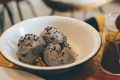 a bowl filled with ice cream on top of a wooden table