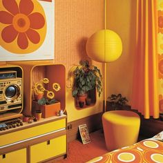 a bedroom with orange and yellow decor on the walls, an old radio in the foreground