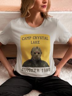 Friday The 13th Jason Camp Crystal Lake Tshirt - Vintage Halloween Jason Voorhees, Friday The Thirteenth Camp Crystal Lake Shirt PREMIUM QUALITY SHIRTS: Our classic unisex jersey short sleeve tee fits like a well-loved favorite. Soft cotton and quality print make users fall in love with it over and over again. These t-shirts have-ribbed knit collars to bolster shaping. The shoulders are tapered for a better fit over time. Dual side seams hold the garment's shape for longer.  SHIRT SPECS:  -Crafted from 100% Airlume combed and ring-spun cotton for lightweight, breathable layering. -The retail fit that is perfect for casual and semi-formal settings. The crew neckline adds a classic, neat style that's perfect for accessorizing. -The tear-away label minimizes skin irritations. -Runs true to si Halloween Crew Neck Tops With Logo Print, Crew Neck Tops With Logo Print For Halloween, Halloween Crew Neck T-shirt With Logo Print, Halloween Logo Print Crew Neck T-shirt, Casual Halloween T-shirt With Logo Print, Jason Camp Crystal Lake, Camp Crystal Lake Shirt, Lake Tshirt, Friday The Thirteenth