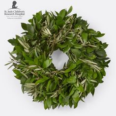 a wreath made out of green leaves on a white background