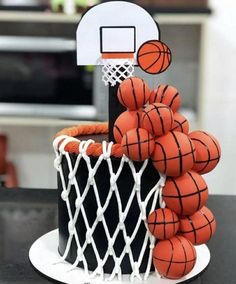 a birthday cake with basketballs and a hoop on top