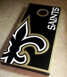 a new orleans saints cornhole board on the floor