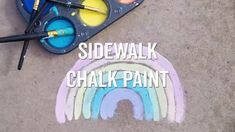 the sidewalk is covered in chalk and paint with rainbows painted on it that says side walk chalk paint