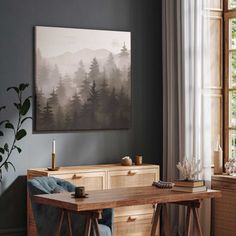 a dining room table with two chairs and a painting hanging on the wall above it