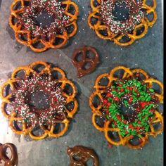 four pretzels with chocolate and sprinkles in the shape of peace signs