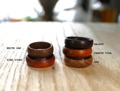 three wooden rings sitting on top of a table next to each other with words written below them