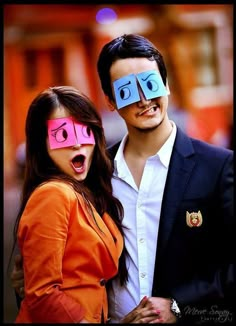 a man and woman are wearing fake glasses with their faces painted like people's eyes