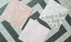 three pieces of fabric laid out on top of a checkerboard floor with one piece missing