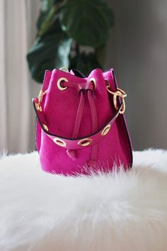 Fritz Bucket Bag Magenta - The Flaunt Chic Crossbody Bucket Bag, Fashion Accessory Bucket Bag With Detachable Strap, Trendy Leather Clutch, Chic Crossbody Bags With Brass Hardware, Chic Clutch With Brass Hardware, Chic Shoulder Bag With Palladium Hardware, Modern Bucket Shoulder Bag With Brass Hardware, Daily Use Crossbody Bucket Bag With Brass Hardware, Leather Shoulder Bag With Palladium Hardware