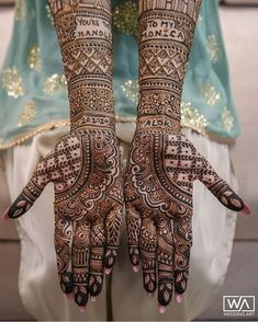 a woman's hands decorated with hennap