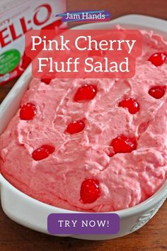 a pink cherry fluff salad in a white bowl next to a carton of jello