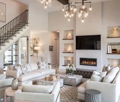 a living room filled with furniture and a fire place in the middle of a room