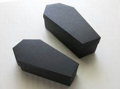 two black boxes sitting on top of a white table