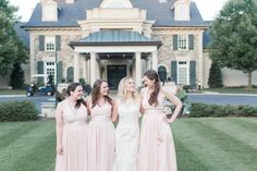 three bridesmaids are standing in front of a large house and posing for the camera