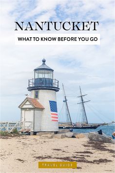 a lighthouse on the beach with a boat in the background