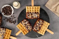 some waffles are on a plate with coffee beans