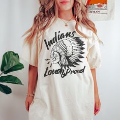 Show your love of the game with this vintage style Loud and Proud Indians mascot design on the popular comfort colors tee. This is a great school spirit shirt for the game and everyday wear! It makes the perfect mom gift or shirt for the coach's wife! This garment-dyed t-shirt is made with 100% ring-spun cotton. The soft-washed, garment-dyed fabric brings extra coziness to your wardrobe while the relaxed fit makes it an excellent daily choice. The double-needle stitching throughout the tee makes Cotton T-shirt With Letter Print For Fan Conventions, Pop Culture Crew Neck Shirt With Screen Print, Pop Culture Screen Print Crew Neck Shirt, Game Day Cotton T-shirt With Screen Print, Cotton T-shirt With Front Print For Fan Conventions, Crew Neck Top With Front Print For Fan Conventions, Graphic Tee With Crew Neck For Fan Conventions, Band Merch Tops With Vintage Print And Short Sleeves, Pop Culture Cotton T-shirt With Front Print