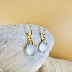 "These gorgeous sea glass drop earrings are made from two pieces of .5-inch smooth, white sea glass, adorned with an elegant gold spiral earring hook. Both hooks and connectors are 18k gold-filled and are hypoallergenic. Come visit my Earring Section for sea glass earrings in other colors and styles! https://www.etsy.com/shop/PendantsForACause?section_id=27147426 ---------- PACKAGING ---------- 🎁 Each handmade piece comes in its own beautiful, velvet-lined jewelry box and is ready to give as a Elegant Sea Glass Dangle Earrings, Sea Glass Teardrop Earrings As Gift, Teardrop Sea Glass Earrings For Gift, Sea Glass Dangle Earrings Gift, Beach Glass Jewelry, Jewelry For Mom, White Sea Glass, Glass Drop Earrings, Beachglass Jewelry