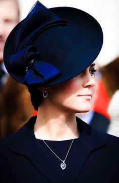 a close up of a woman wearing a blue hat