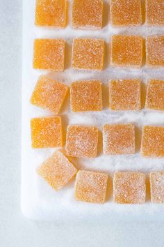 some sugar cubes are sitting on a white plate and have been cut into squares