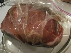 a piece of meat wrapped in plastic on a plate