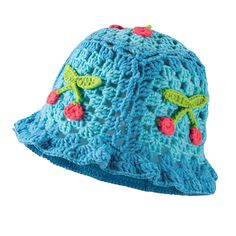 a crocheted blue hat with cherries on it