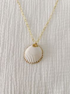 This is for 1 gold plated necklace with a large white cockle shell with gold lining! Shell is 1.5" and pretty lightweight. It will make the perfect statement piece! Please select the chain length you would like For best use, do not wear in water/salt water/sweat or to bed and keep away from perfume/lotion :) Affordable Shell-shaped Shell Necklace For Gifts, Luxury Shell Necklace For Women, Casual Cheap Shell Necklace For Gift, Cheap Shell Necklace Gift, Cheap Round Shell Necklace For Gift, Cheap Ocean-inspired Shell Necklace For Gift, Casual Cheap Shell Necklace As Gift, Cheap Shell-shaped Necklaces For Gifts, Cheap Shell Necklaces For Gifts