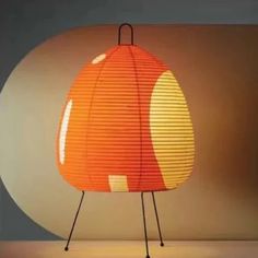 an orange and yellow lamp sitting on top of a table