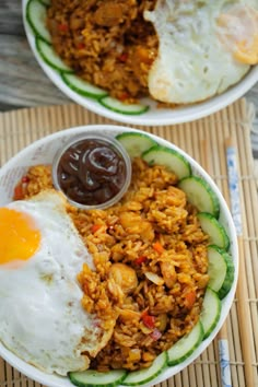 two bowls filled with rice, meat and vegetables