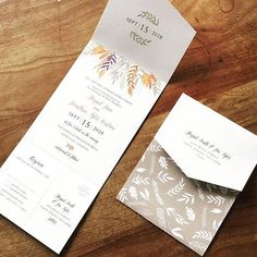 the wedding stationery was designed to look like an envelope with leaves and foliage on it