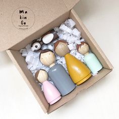 a box filled with small wooden toys on top of a table