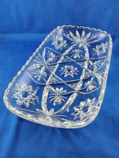 a clear glass dish on a blue cloth