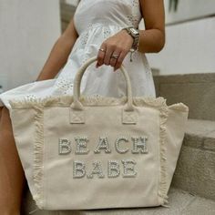 Welcome to our charming Etsy store, where we present our latest must-have accessory: a stunning Canvas Tote with personalized pearl lettering. This versatile bag is designed to cater to every individual, but it holds a special allure for all beach babes. It couldn't be more ideal as a gift, making it a delightful choice for those embarking on their vacation plans or just a day at the beach or pool. With the option to add the touch Beach Babe, Salty beach, Salty Vibes or your unique last name, th White Letter Print Bags For Summer, White Canvas Shopping Bag For Beach Season, Large Capacity White Canvas Bag For Beach Season, White Letter Print Tote Beach Bag, Trendy White Beach Bag With Letter Print, Vacation Rectangular Shoulder Bag With Letter Print, Large Capacity Canvas Bag For Beach Season, Rectangular Shoulder Bag With Letter Print For Vacation, Beige Bags With Letter Print For Summer