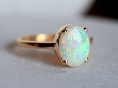 a white opal ring sitting on top of a table