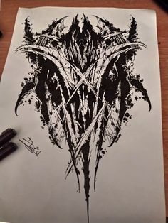 an ink drawing of a demon head on paper