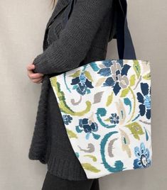 "Weather off shopping, to the beach or grabbing a few books at the library, This shoulder tote bag is perfect for a day out. It is made from royal blue canvas and  floral blue designer fabric and has a snap closure.  Dimensions:  Bag - 12 1/2\" x 13 1/2\"  Shoulder Straps - 2\" x 28 1/2\"  Pocket - 8\" x 7\"" Blue Canvas Beach Bag For Shopping, Blue Cotton Beach Bag For Shopping, Blue Canvas Beach Bag For Daily Use, Everyday Blue Canvas Beach Bag, Casual Blue Canvas Beach Bag, Blue Reversible Canvas Bag, Reversible Blue Shoulder Bag For Beach, Reversible Blue Shoulder Bag For The Beach, Reversible Blue Shoulder Bag For Shopping