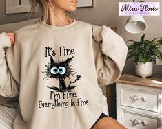 It's Fine I'm Fine Everything is Fine Sweatshirt, Introvert Sweatshirt, Sarcastic Sweat, I'm Fine, Everything is Fine T-Shirt, Mental Shirt Unisex Sizing Across All Products Discover your perfect fit with our size and color guides, available in the product photo gallery. How to Order from Our Etsy Store Excited about our offerings? Follow these easy steps to make them yours: 1. Explore: Browse our curated collection and find products that resonate with your style. Our attention to detail shines through in every piece. 2. Select: Found something you love? Click on it for more details like size, color, and personalization options. 3. Customize: Pick your preferences from the dropdown menus. For personal touches, use the provided text box for your specifications. 4. Add to Cart: Once you're s Cat Grumpy, Funny Animal Shirts, Sarcasm Shirts, Ew People, Cozy Cat, Cute Black Cat, Cat Lover Shirt, Lazy Cat, Cute Black Cats